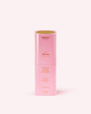 A pink cylindrical bottle of Truly Beauty The Hydrating Face Serum with gold text stands upright on a light pink background. The partially open bottle reveals the inside of the cap.