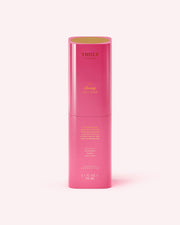 A tall, cylindrical pink bottle of Truly Beauty The Clearing Body Serum (3.1 fl oz/90 mL), designed to target large pores and body acne, features gold and yellow text and is displayed against a pale pink background.