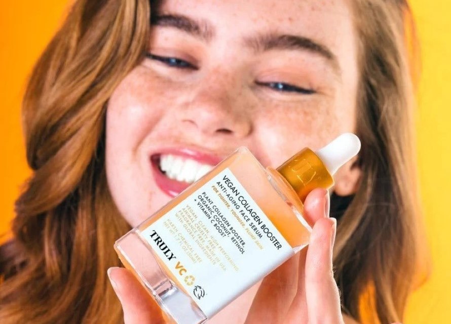Do I Apply Serum to Dry Skin? | young woman smiling and holding truly's vegan collagen serum