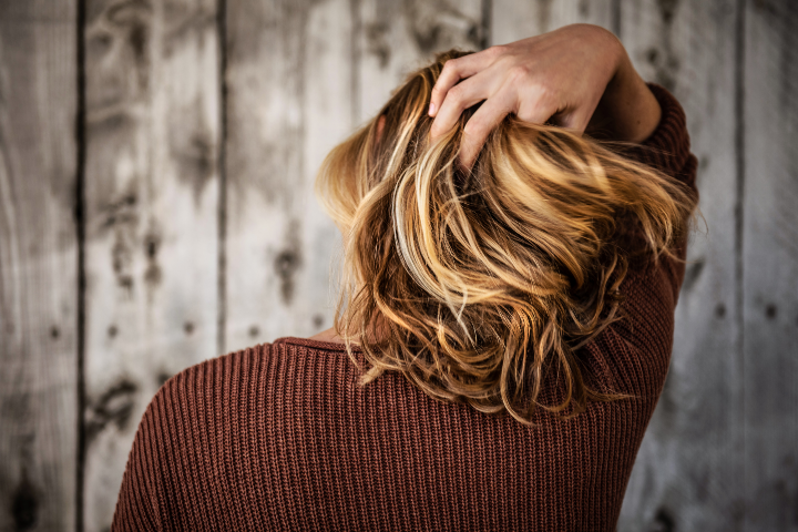 Woman holding back of hair