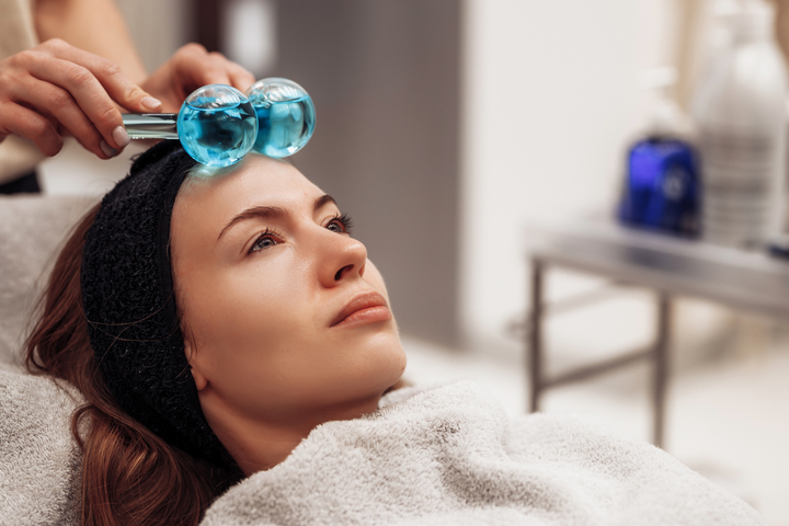 woman getting ice globe facial