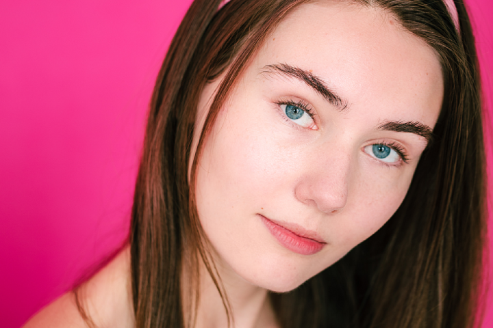 young woman with brown hair and blue eyes