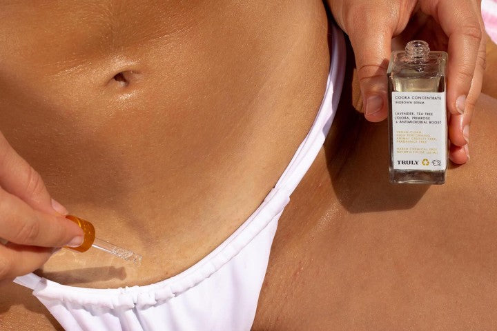 Closeup of Truly's cooka oil being applied to bikini area with dropper