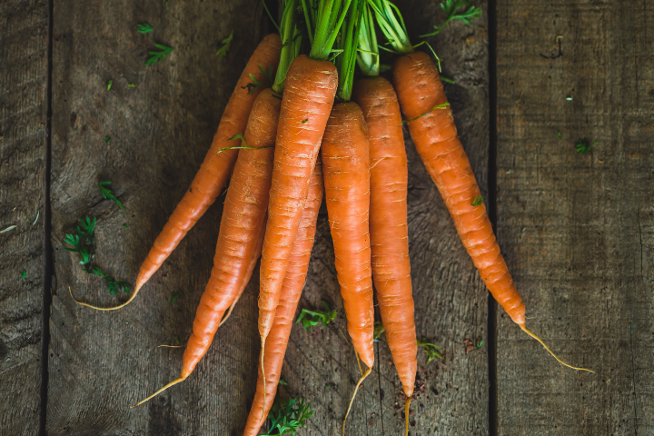 A bunch of carrots on wooden table