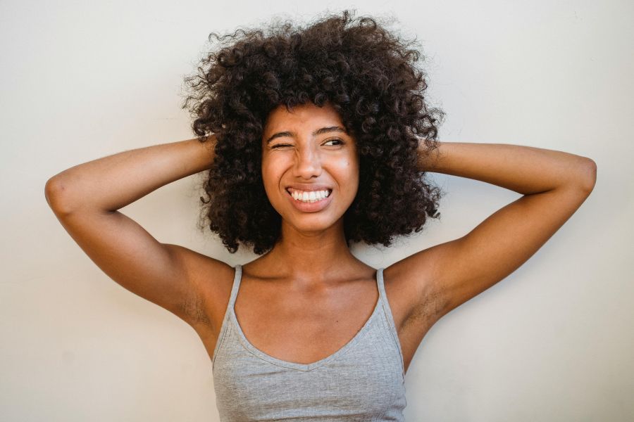 why is my deodorant not working | Charismatic black woman against white wall