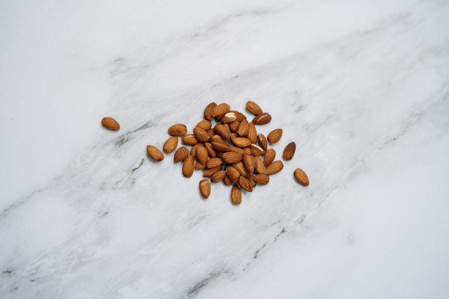 protein for skin | handful of almonds on marble surface
