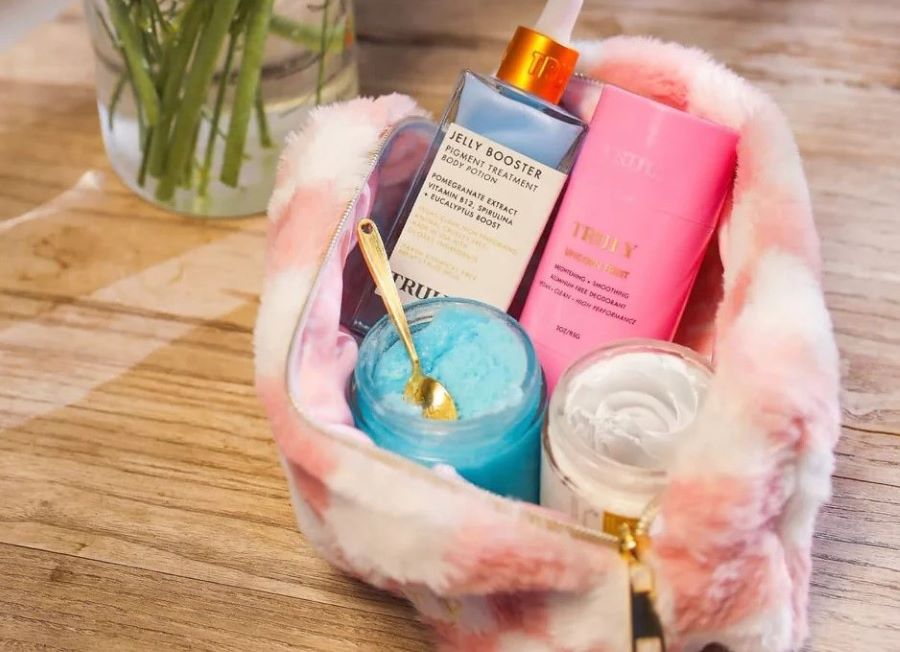 can you bring deodorant on a plane | Truly's pit perfecting set in pink bag on table