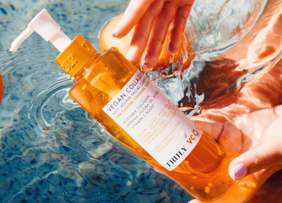 glycolic acid and vitamin C | Truly's vegan collagen facial cleanser dipped in water
