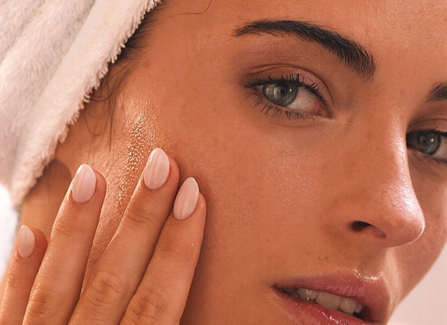 how to exfoliate skin | closeup of woman touching cheek