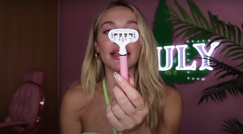 is shaving your face bad for a woman? | Truly beauty's Zara face shaving tutorial screen capture holding razor in front of face