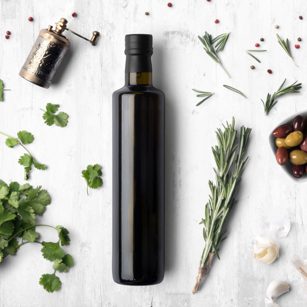 vinegar bath | bottle of vinegar surrounded by herbs