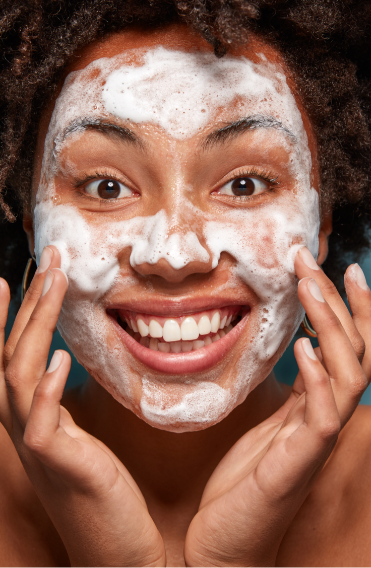 woman with foam cleanser on face