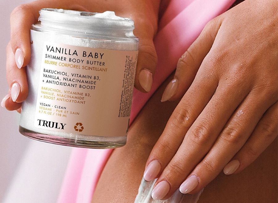 vanilla benefits for skin | woman holding jar of vanilla baby body butter and applying it to skin