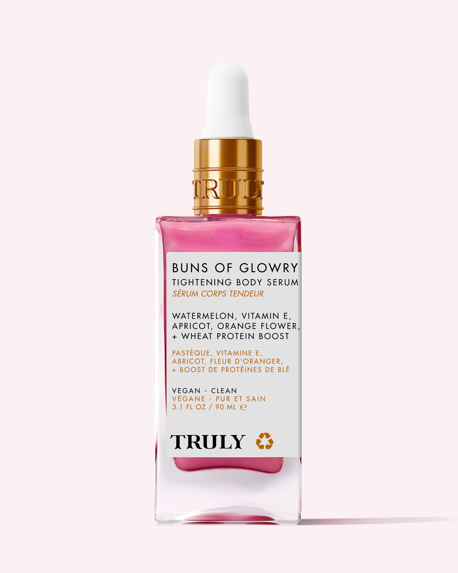 A pink glass bottle of Truly Beauty Buns Of Glowry Tightening Body Serum with a gold dropper. The label highlights key ingredients like watermelon, vitamin E, apricot, and wheat protein for ultra-hydrated, firmer-looking skin.