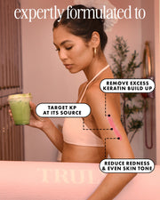 A woman in a beige sports bra holds a green smoothie, looking at her upper arm. Text highlights Truly Beauty’s Smooth Legend After Shave Serum: smooths strawberry skin, removes excess keratin, targets Keratosis Pilaris, reduces redness, evens tone.