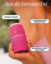 A hand holds a pink Truly Beauty Unicorn Fruit Skin Brightening and Smoothing Deodorant. Text highlights its benefits: combats odors, brightens underarms with niacinamide, and evens skin tone. Part of a person's shoulder and arm appears in the background.