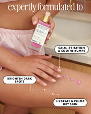 A person applies pink drops from a bottle labeled Truly Beauty Unicorn Fruit After Shave Serum, which hydrates dry skin, calms irritation, brightens dark spots, and soothes ingrown hair.