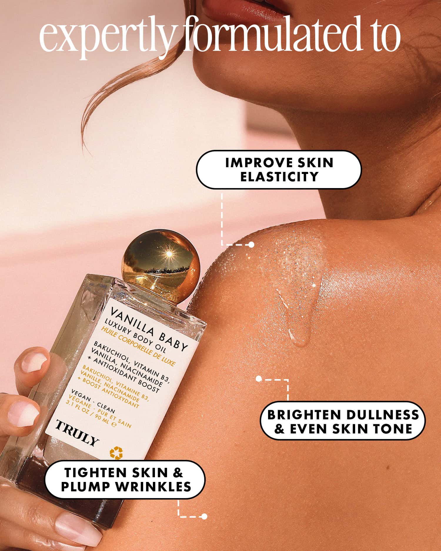 A person applies Truly Beauty Vanilla Baby Luxury Body Oil to their shoulder. Text highlights its benefits: firms, improves elasticity, brightens dull skin, evens tone, and offers anti-aging effects.
