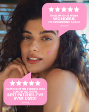 A woman with long, wavy hair rests her chin on her hand, wearing Truly Beauty’s #Heart Your Imperfections Blemish Patch. Reviews call these pink heart-shaped patches wonders and the best blemish treatment they've ever tried.