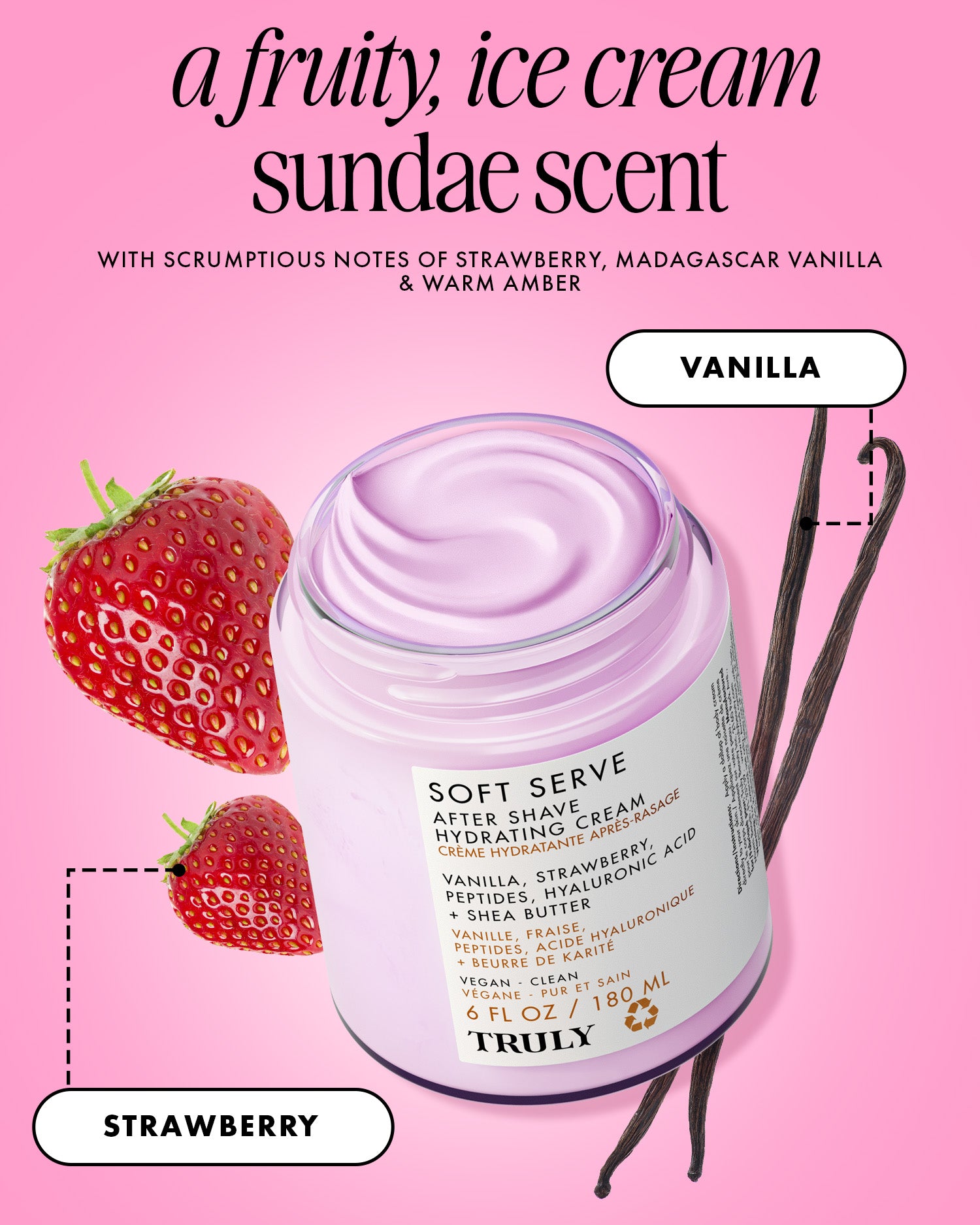 An open jar of Soft Serve After Shave Hydrating Cream by Truly Beauty, filled with pink cream, is surrounded by strawberries and vanilla beans on a pink background, showcasing its strawberry and vanilla scent.