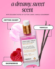 A bottle of Truly Beauty’s Unicorn Fruit After Shave Serum, an ingrown hair treatment, sits among cotton candy, vanilla beans, and raspberries to highlight its sweet scent notes against a dreamy pink background.