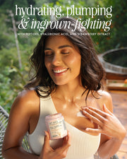 A smiling woman in a white tank top applies Soft Serve After Shave Plump Cream by Truly Beauty to her shoulder, holding the jar. Text above reads: “hydrating, plumping & ingrown-fighting” with key ingredients listed below.
