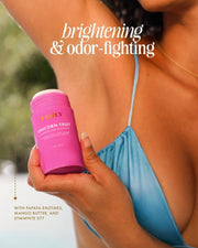 A person in a blue bikini holds a pink Truly Beauty Body Brightening Set container to their armpit. Text reads 