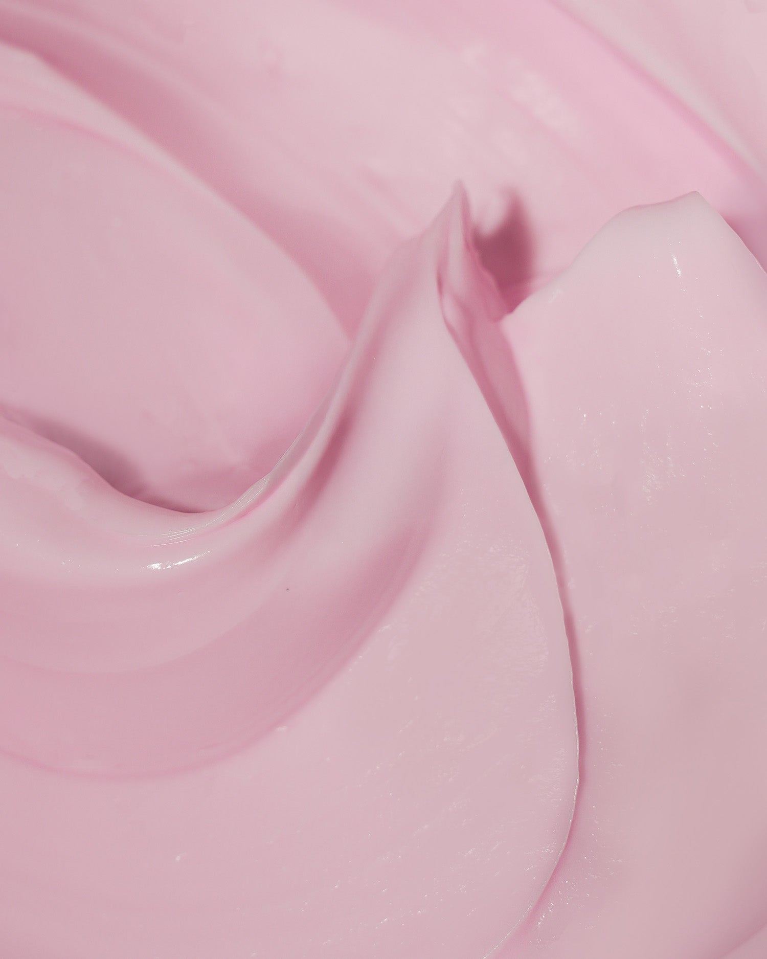 Close-up of Truly Beautys Soft Serve After Shave Plump Cream—a smooth, creamy pink formula with glossy swirls, designed to hydrate skin and combat ingrown hairs.
