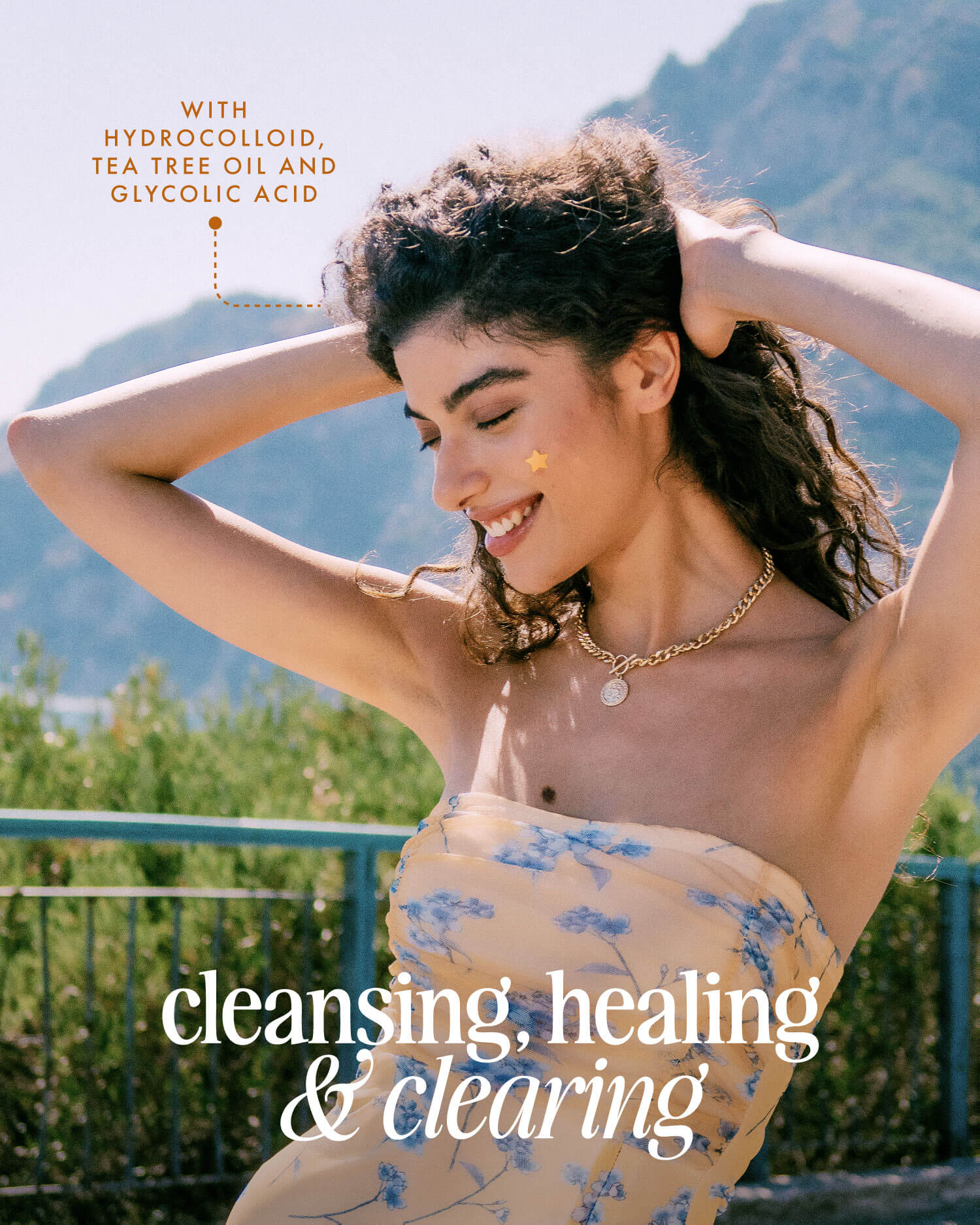 A smiling woman in a floral dress stands outdoors with mountains behind her, as text highlights Truly Beauty’s Our Stars Prevent Scars Blemish Patches for cleansing, healing, and clearing.