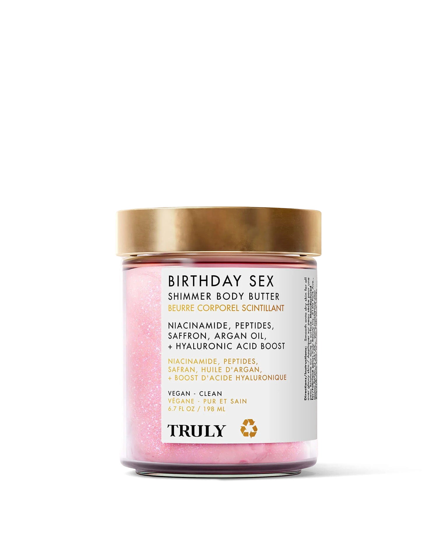 A 6.7 fl oz (198 mL) jar of Truly Beauty’s Birthday Sex Shimmer Body Butter features a gold lid, pink illuminating cream, and a label highlighting hydrating niacinamide, argan oil, and peptides.
