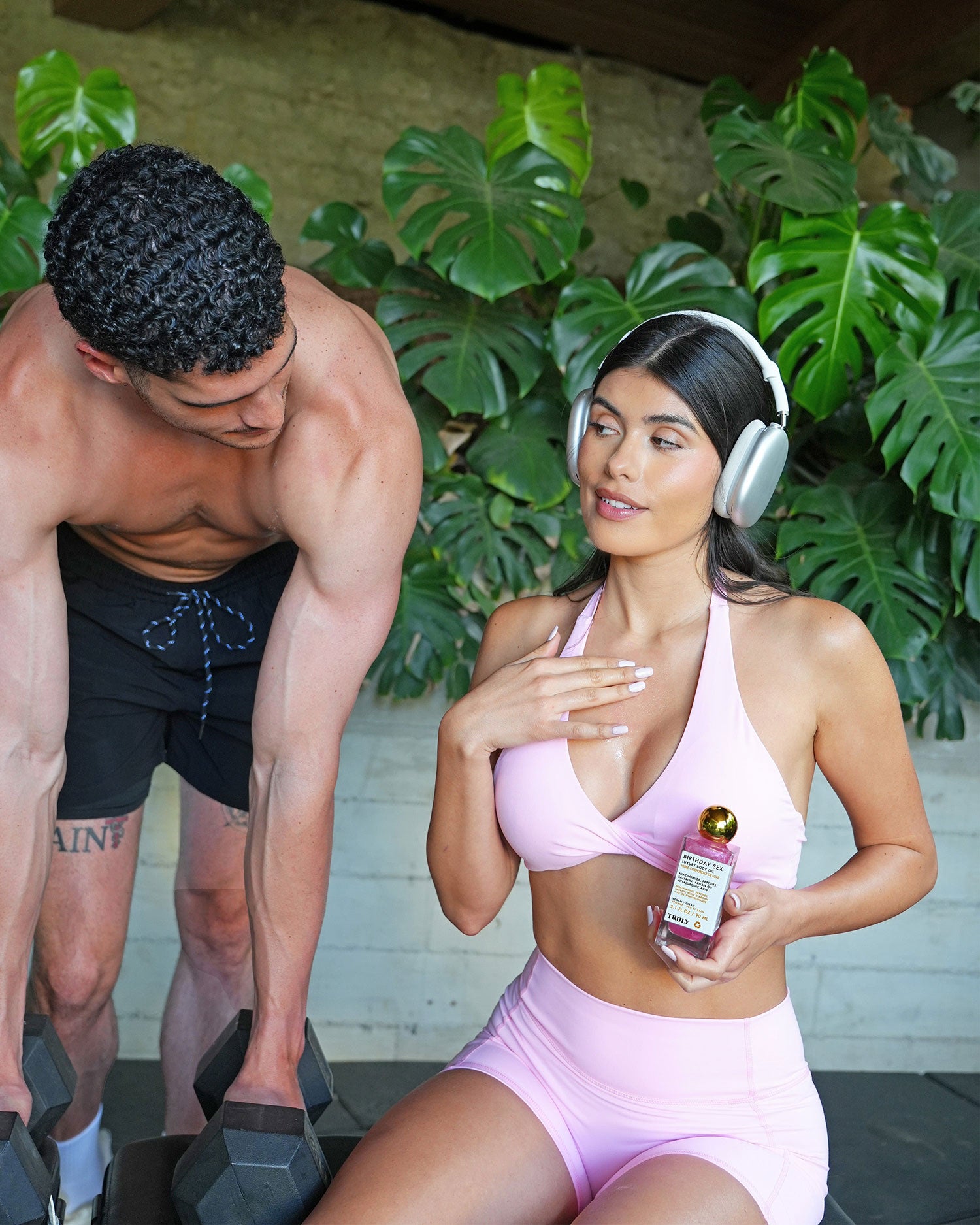 Man and woman in workout attire with a product in a fitness setting