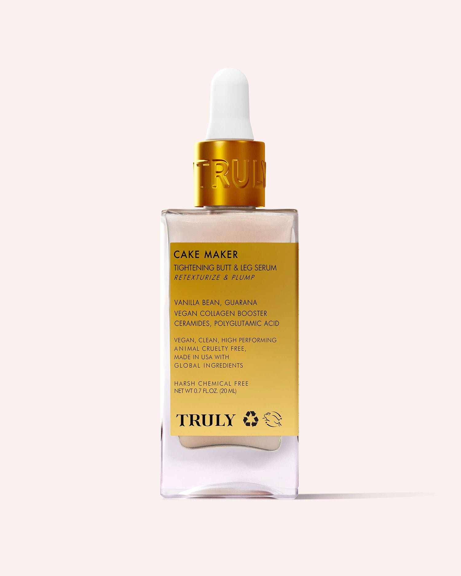 A bottle of Truly Beauty Cake Maker Serum Mini, a travel-size skincare essential with a gold label and white dropper cap, showcasing product details and key ingredients against a light beige background.