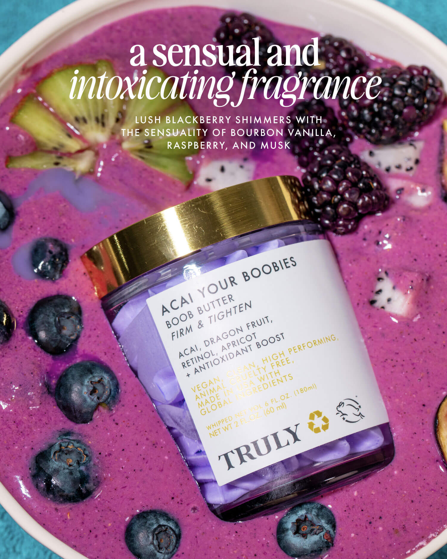 A jar of Truly Beautys Acai Your Boobies Butter sits on a purple smoothie bowl with blackberries and blueberries. Text above spotlights its sensual, intoxicating fragrance that leaves skin irresistibly smooth.