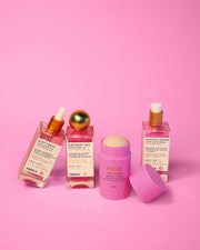 The Tiktok Pink Routine by Truly Beauty is displayed on a pink background, featuring three dropper bottles and a pink stick for the perfect pink skincare set.