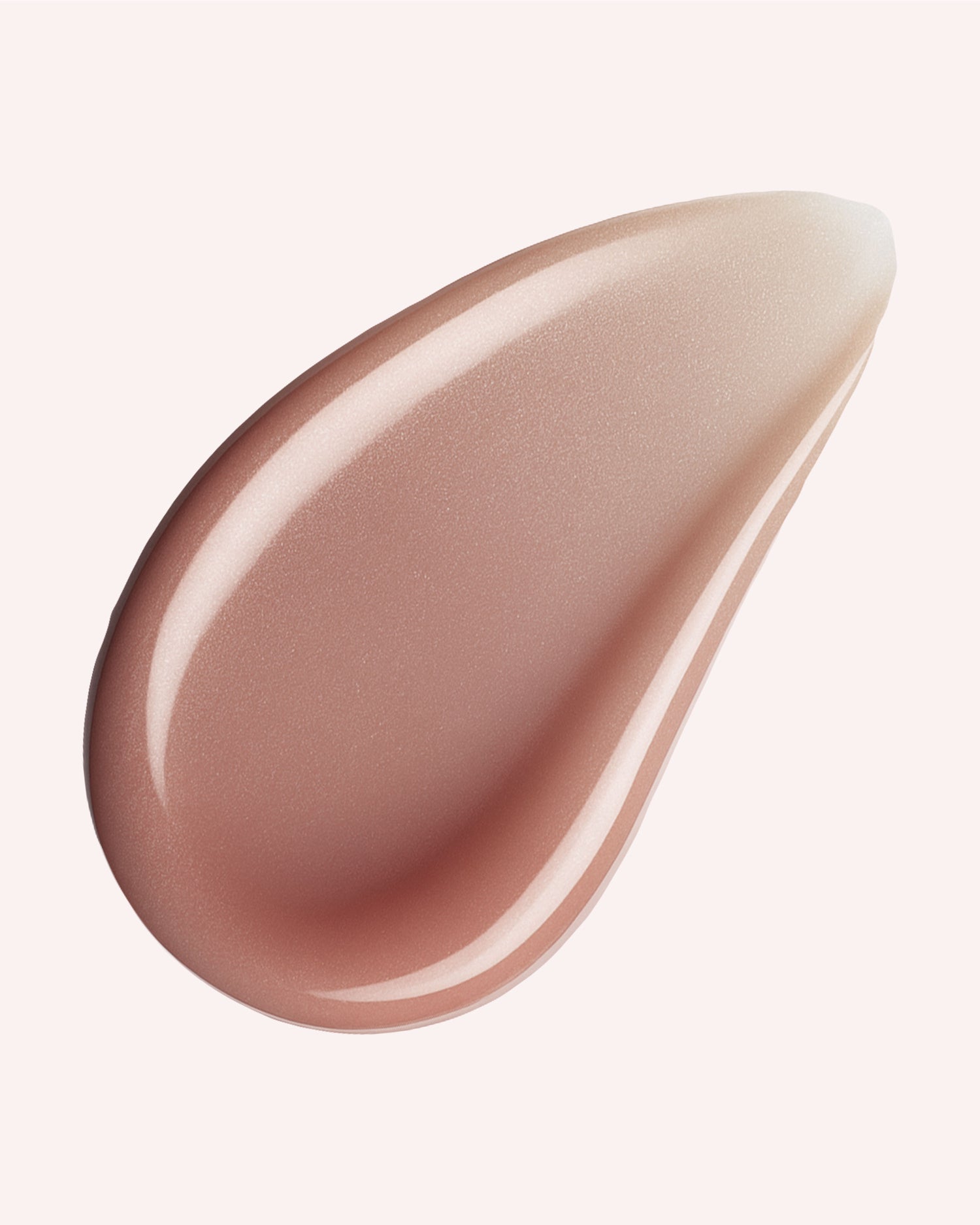 A close-up of a smooth, glossy, beige-pink smear from The Glossy Duo by Truly Beauty on a pale background, highlighting the hydrating texture of this premium lip oil.