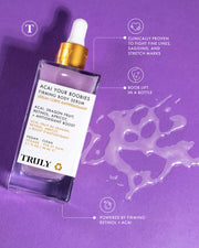A bottle of Truly Beauty’s Acai Your Boobies Firming Body Serum rests on a purple surface with spilled serum nearby, while callouts highlight benefits like firming and smoothing skin with moisturizing retinol and acai extract.