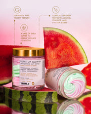 An open jar of Truly Beauty’s Buns of Glowry Smoothing Butt Butter sits next to a closed one, surrounded by watermelon slices. The pastel pink, green, and cream swirl highlights its shea butter base and watermelon extract for glowing skin.