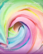 A close-up of Truly Beauty’s Unicorn Fruit Duo pastel, rainbow-hued whipped body butter features text on its key ingredients—shea butter, vegan collagen, and matcha—their skincare perks, and a subtle cotton candy scent.