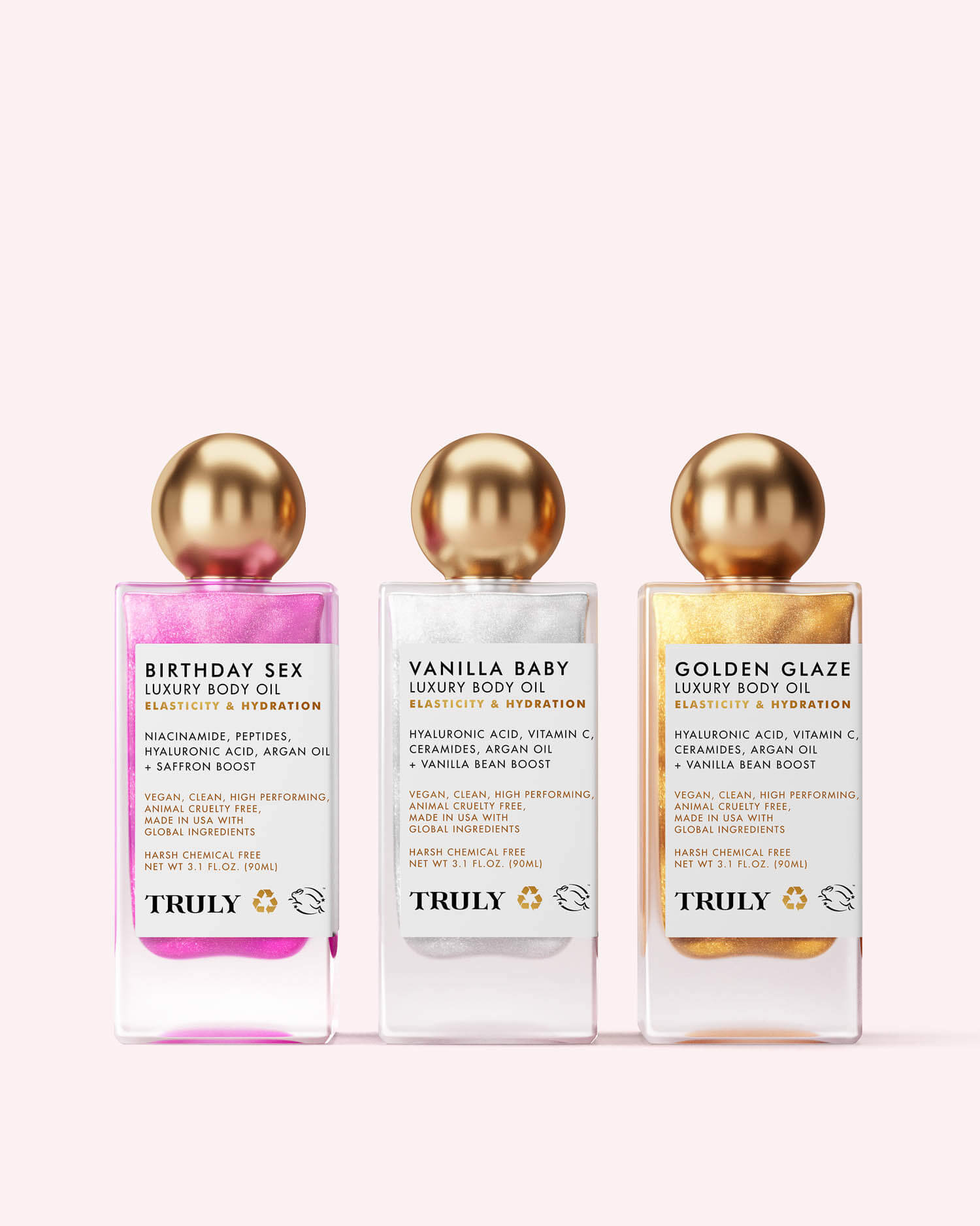 The Truly Beauty Luxury Body Oil Trio features three shimmer oils—Birthday Sex (pink), Vanilla Baby (white), and Golden Glaze (gold)—in gold-capped bottles, each enriched with bakuchiol and vitamin C.