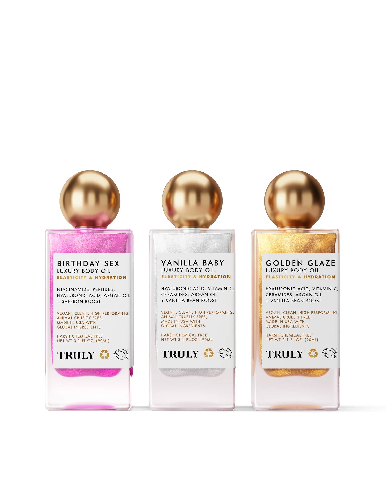 The Truly Beauty Luxury Body Oil Trio features three nourishing shimmer oils—Birthday Sex (pink), Vanilla Baby (white), and Golden Glaze (gold)—all topped with gold caps and infused with vitamin C for radiant skin.