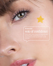 A close-up of a womans face with a yellow star sticker on her cheek. Text overlay: Vote of confidence. I love that Truly Beauty’s Our Stars Prevent Scars Blemish Patches really stick—even under clothes and on my body!.