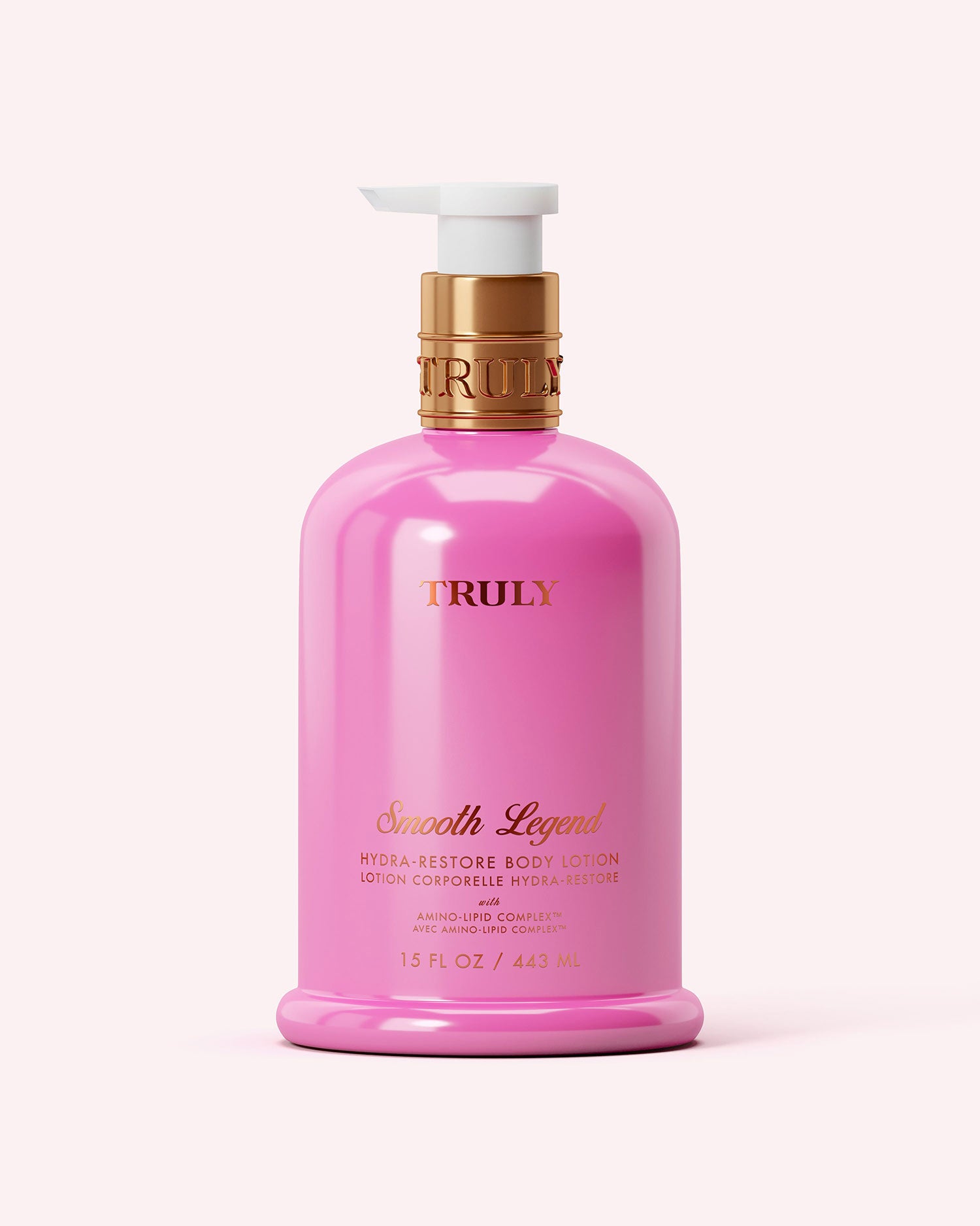 A 15 fl oz (443 ml) pink bottle of Truly Beauty's Hydra-Restore Body Lotion with gold and white pump and gold lettering, set against a soft pink background. Enriched with Amino-Lipid Complex for long-lasting hydration.