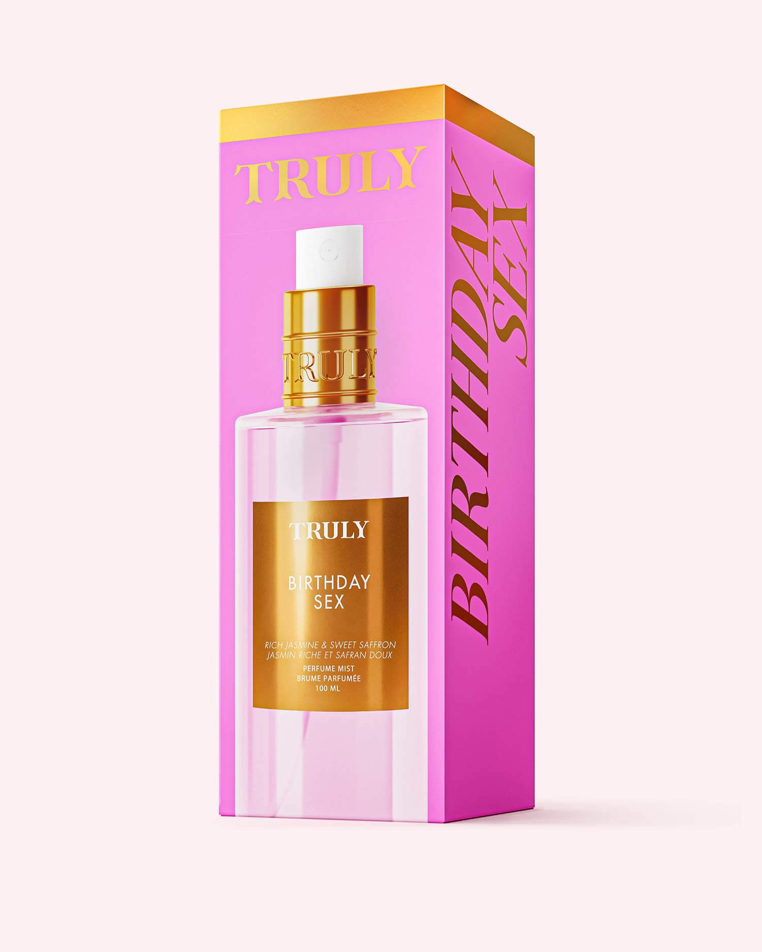 A clear bottle labeled “Birthday Sex Perfume Mist” by Truly Beauty stands before pink and gold packaging with “Truly” in gold on top and “Birthday Sex” on the side, highlighting its bold spicy floral scent with jasmine and patchouli notes.