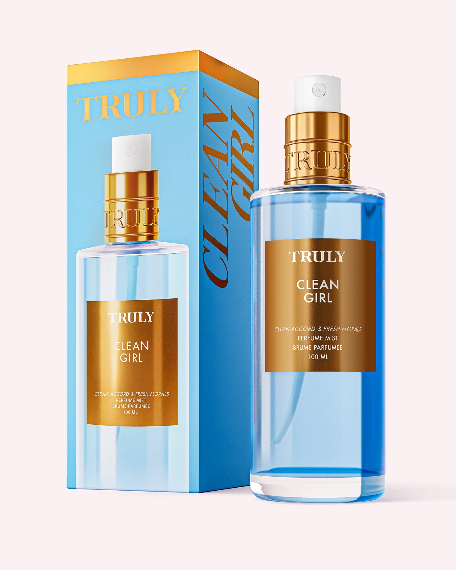 A bottle of Truly Beauty’s Clean Girl Perfume Mist, with blue liquid and gold and white accents, stands beside its box. Both display the product’s name, suggesting a fresh floral scent for an effortlessly chic vibe.