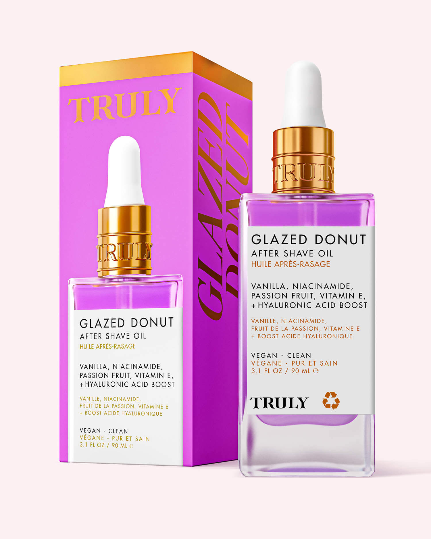 A bottle of Glazed Donut After Shave Oil with a gold dropper sits beside its pink and orange box. This serum hydrates, smooths, and softens skin after shaving with vanilla, niacinamide, passion fruit, and vitamin E.