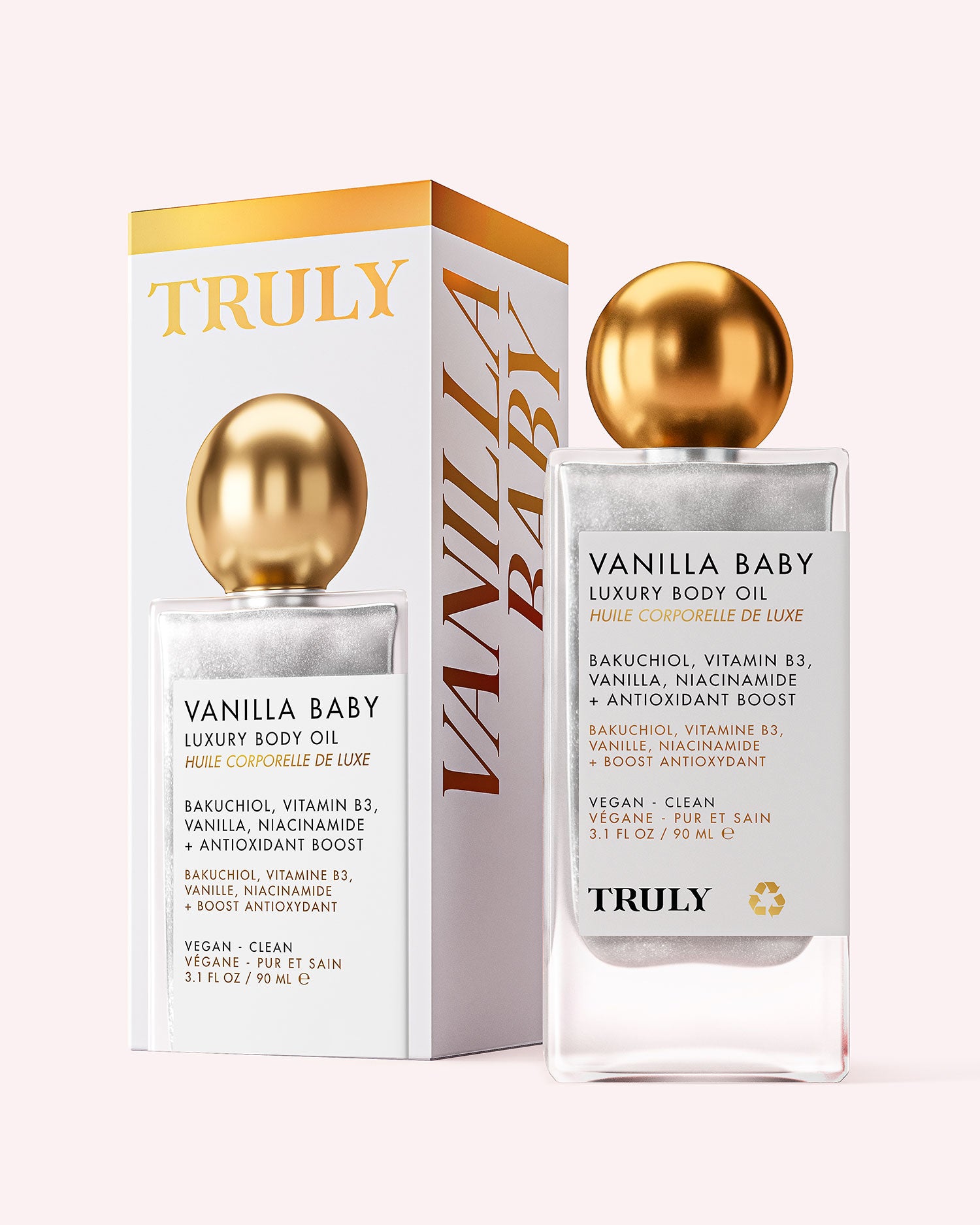 A bottle and box of Truly Beauty’s Vanilla Baby Luxury Body Oil with a gold spherical cap. The white and gold packaging highlights anti-aging ingredients like bakuchiol, vitamin B3, and niacinamide for plump, radiant skin.