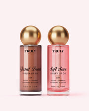 Two bottles of The Glossy Duo by Truly Beauty are shown side by side: the left, 