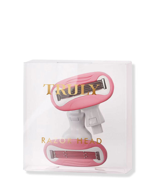 Two pink and white double-blade Razor Cartridges by Truly Beauty come in a clear plastic box labeled TRULY RAZOR HEAD in gold, designed to give you a silky smooth shave.