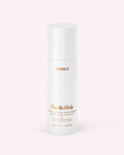 A white cylindrical bottle labeled Hydra-Smooth Shave Cream by Truly Beauty, with gold and peach text, sits on a light pink background. The bottle contains 5 fl oz (147 ml) of product.