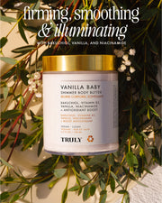 A Vanilla Baby Luxury Trio by Truly Beauty rests on a surface with small white flowers. The label showcases bakuchiol, vanilla, niacinamide, and vitamin B3 for luminous skin. Text above says: firming, smoothing & illuminating.